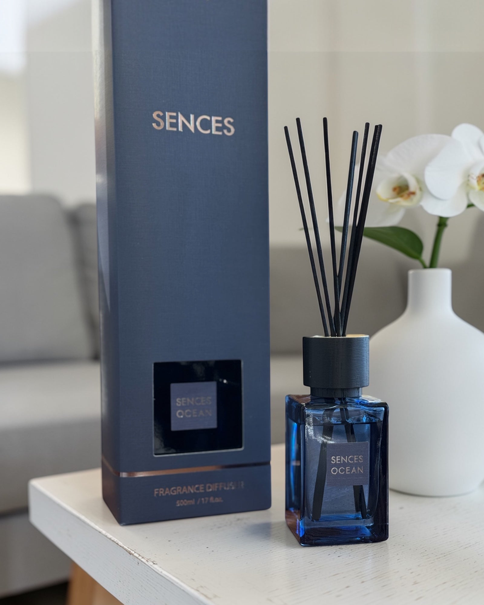 Navy blue Coach House Ocean Reed Diffuser with natural reeds, showcasing a large, coastal-themed home fragrance bottle.