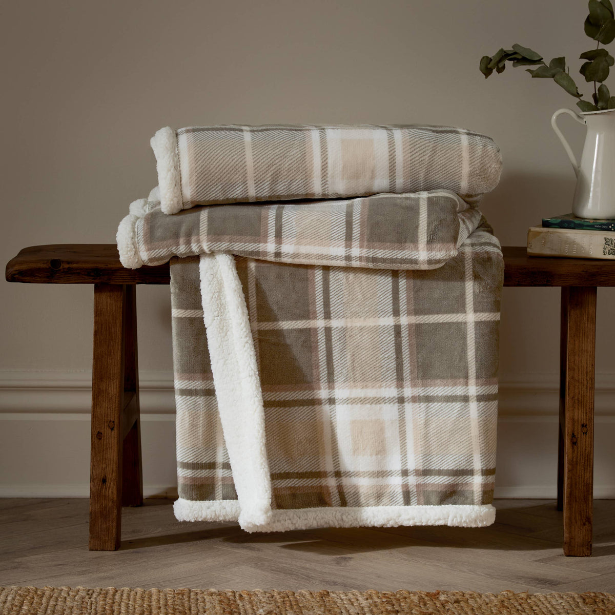 Riva Home Braemar check sherpa fleece throw in green and natural tones folded on display