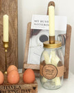 Ivory Candles In A Glass Storage Jar And Holder