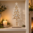 Wooden Tree With White Bells, wooden tree with hanging bells on a recessed shelf