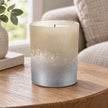 Faded Bronze Glass Tealight Holder, bronze and silver glass holder with an unlit candle on a side table