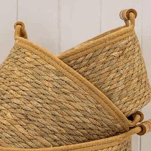 Natural woven rope basket with handles from Satchville, ideal for home decor storage and organization.