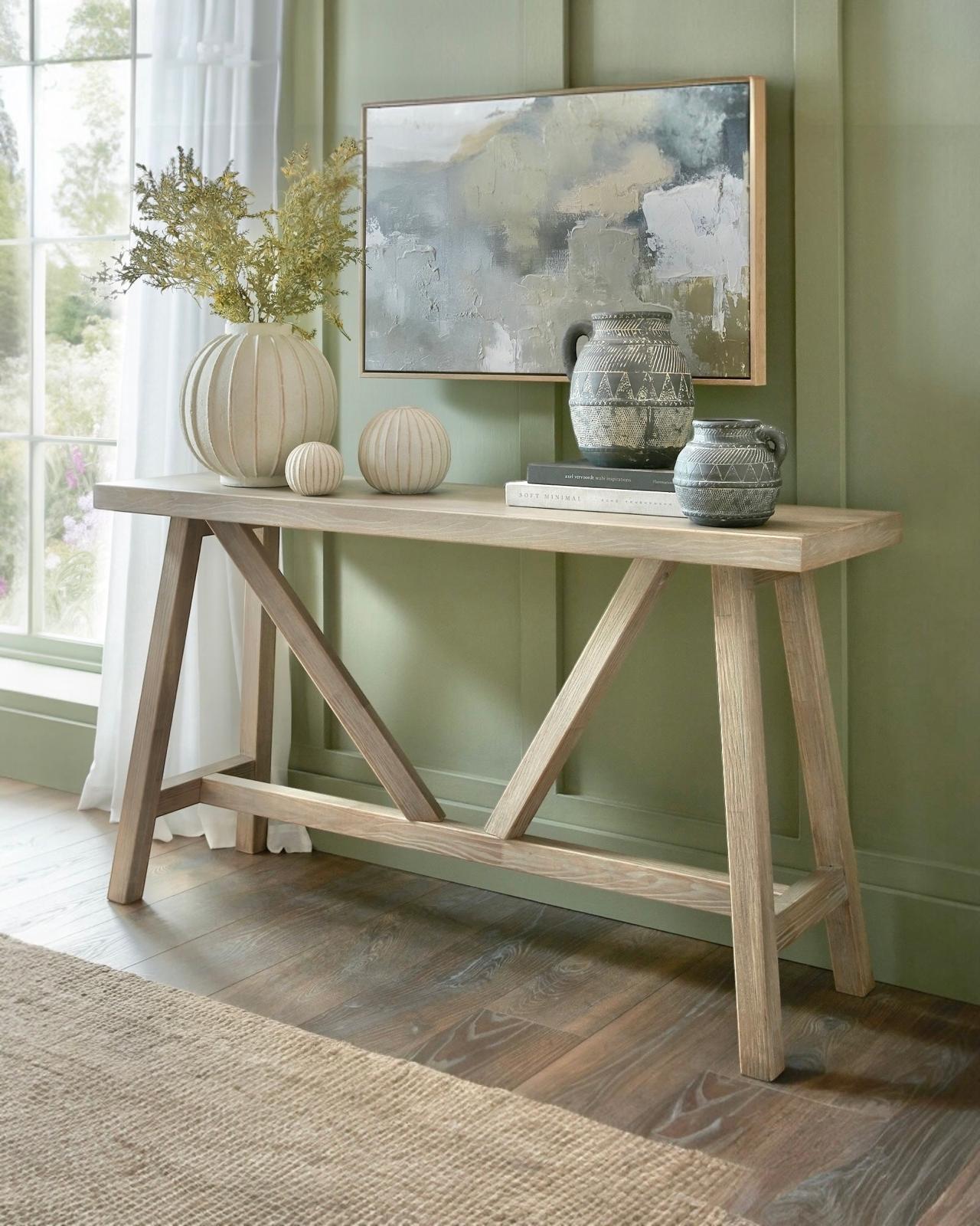 Wooden console table from Hill Interiors' Haldon Collection, featuring a sleek design with a spacious top and sturdy legs.