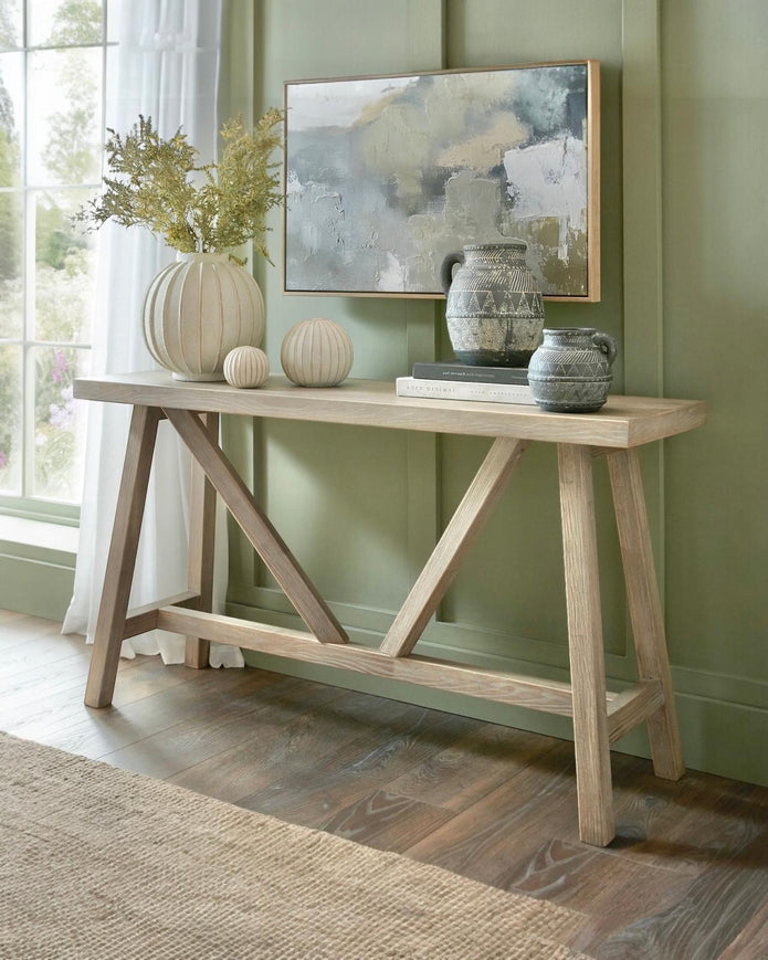 Wooden console table from Hill Interiors' Haldon Collection, featuring a sleek design with a spacious top and sturdy legs.