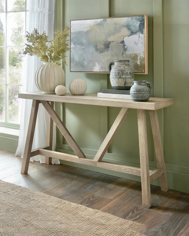 Wooden console table from Hill Interiors' Haldon Collection, showcasing a sleek, modern design with a smooth finish.