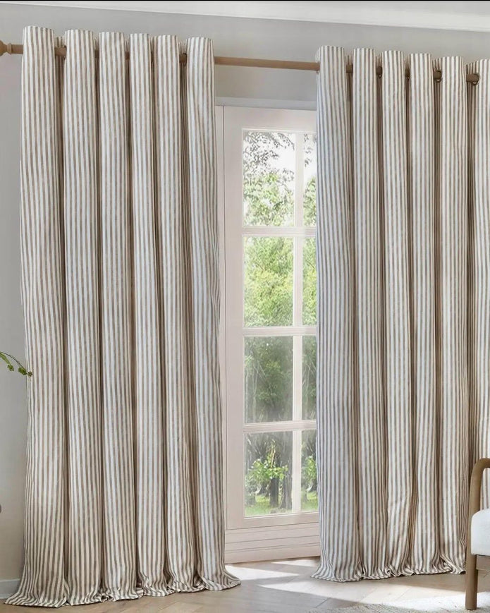 Riva Home Yard Natural striped blackout eyelet curtains in black and white hanging in a living room window.