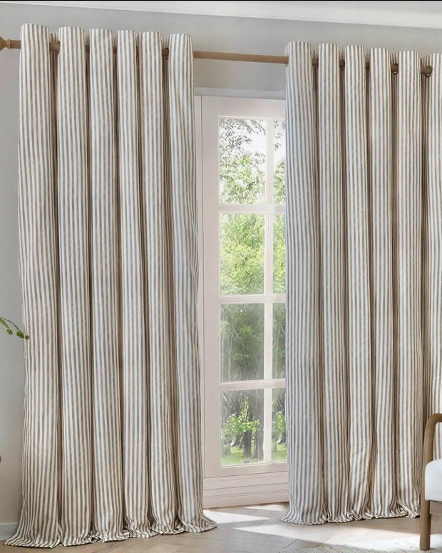 Riva Home Yard Natural striped blackout eyelet curtains in black and white hanging in a living room window.