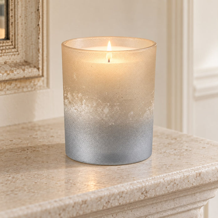 Faded Bronze Glass Tealight Holder, glowing bronze and silver glass holder on a stone mantel
