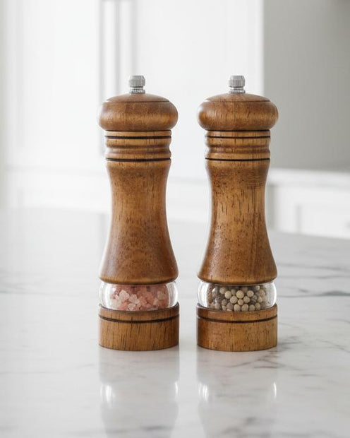 Wooden Salt And Pepper Mills - Set of Two, pair of wooden salt and pepper mills by a window