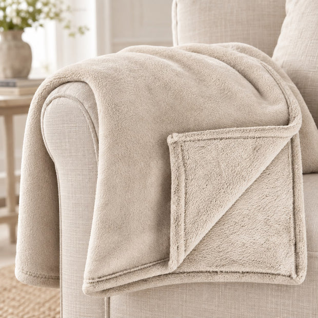 Cream Luxury Snuggle Blanket Throw, close-up of the cream throw and folded corner on a sofa arm