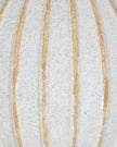 Decorative globe ball with striped pattern, used as a home décor accent by Hill Interiors.