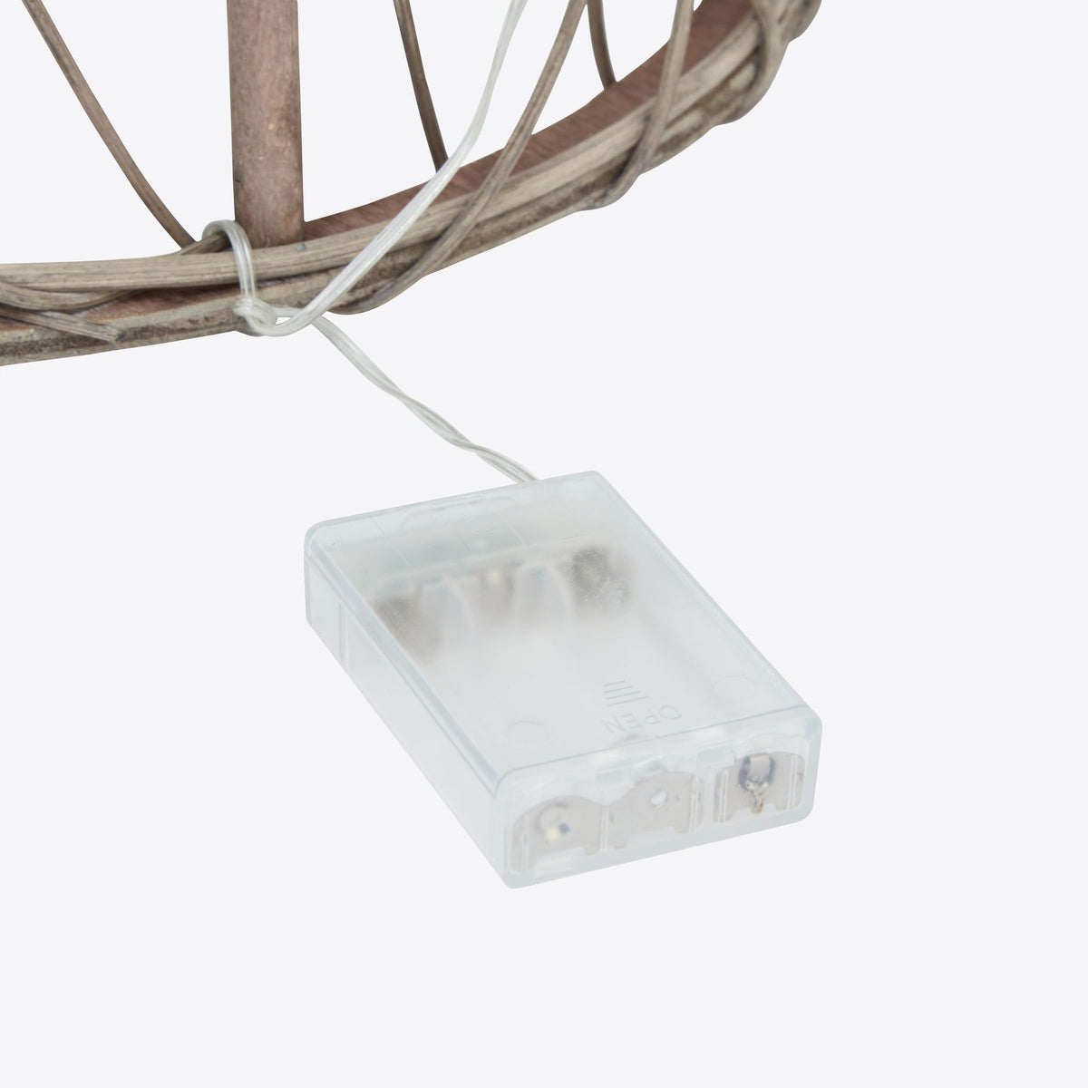 Close-up of the rattan Christmas tree battery box and connecting wire.