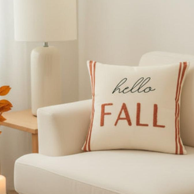 Hello Fall Printed Cream and Orange Cushion Cover, Hello Fall cushion beneath a lamp in a neutral room
