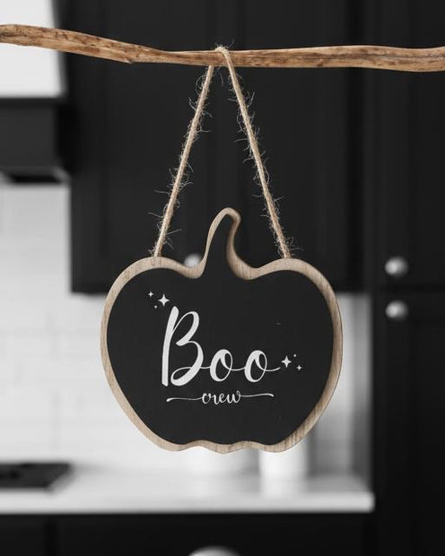 Boo Crew Wooden Hanging Pumpkin Sign, black pumpkin-shaped Boo Crew sign hanging from a branch