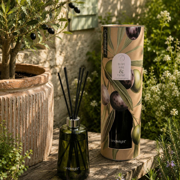 Reed Diffuser - Olive Vine & Thyme 300ml, green reed diffuser with black reeds and botanical tube outdoors