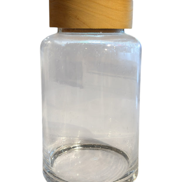 Glass Jar With Wooden Lid, empty clear jar with a wooden knobbed lid against white