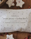 bobella co sweet peony & lychee berry wax melts packaging on a wooden surface with star-shaped wax melts.
