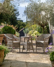Natural rattan Menton two-seat bistro set for garden from Gallery Direct featuring woven rattan chairs and a matching table.