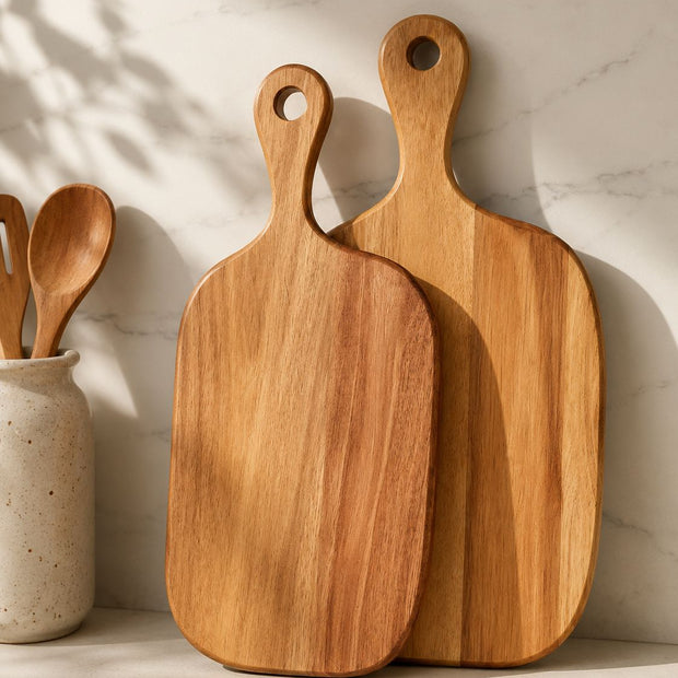 Dark Wood Chopping Serving Board, two wooden handled boards leaning against a kitchen wall