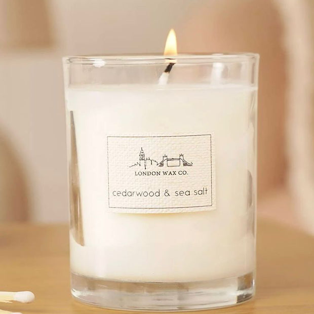 London Wax Company Lidded Candle - Cedarwood and Sea Salt, lit Cedarwood and Sea Salt candle in clear glass