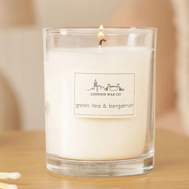 London Wax Company Lidded Candle - Green Tea & Bergamot, lit Green Tea and Bergamot candle in a clear jar