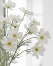 Artificial Cream Cosmos Flower Stem from Starlight Express, realistic cream-colored cosmos flower on a green stem for decorative use.