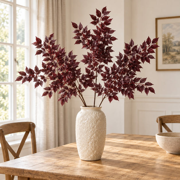 Artificial Burgundy Leaf Foliage Stem, burgundy foliage in a cream vase on a wooden dining table