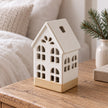 White ceramic LED light-up house for home decor by Sifcon, illuminated ceramic figure with detailed windows and roof.
