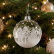 White Glass Bauble With Snowy Winter Scene, clear bauble with a snowy white woodland scene on a tree