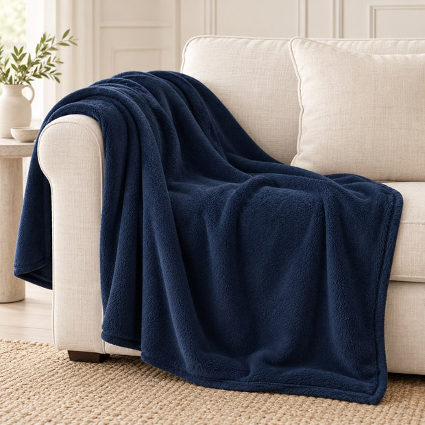 Navy Blue Luxury Snuggle Blanket Throw, navy blue throw draped over a cream sofa