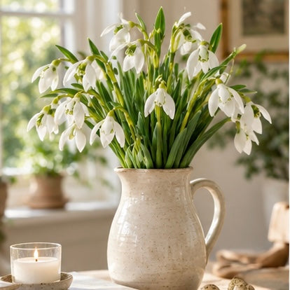 White Snowdrop stem from Starlight Express, artificial spring flower with delicate white blooms and green foliage.