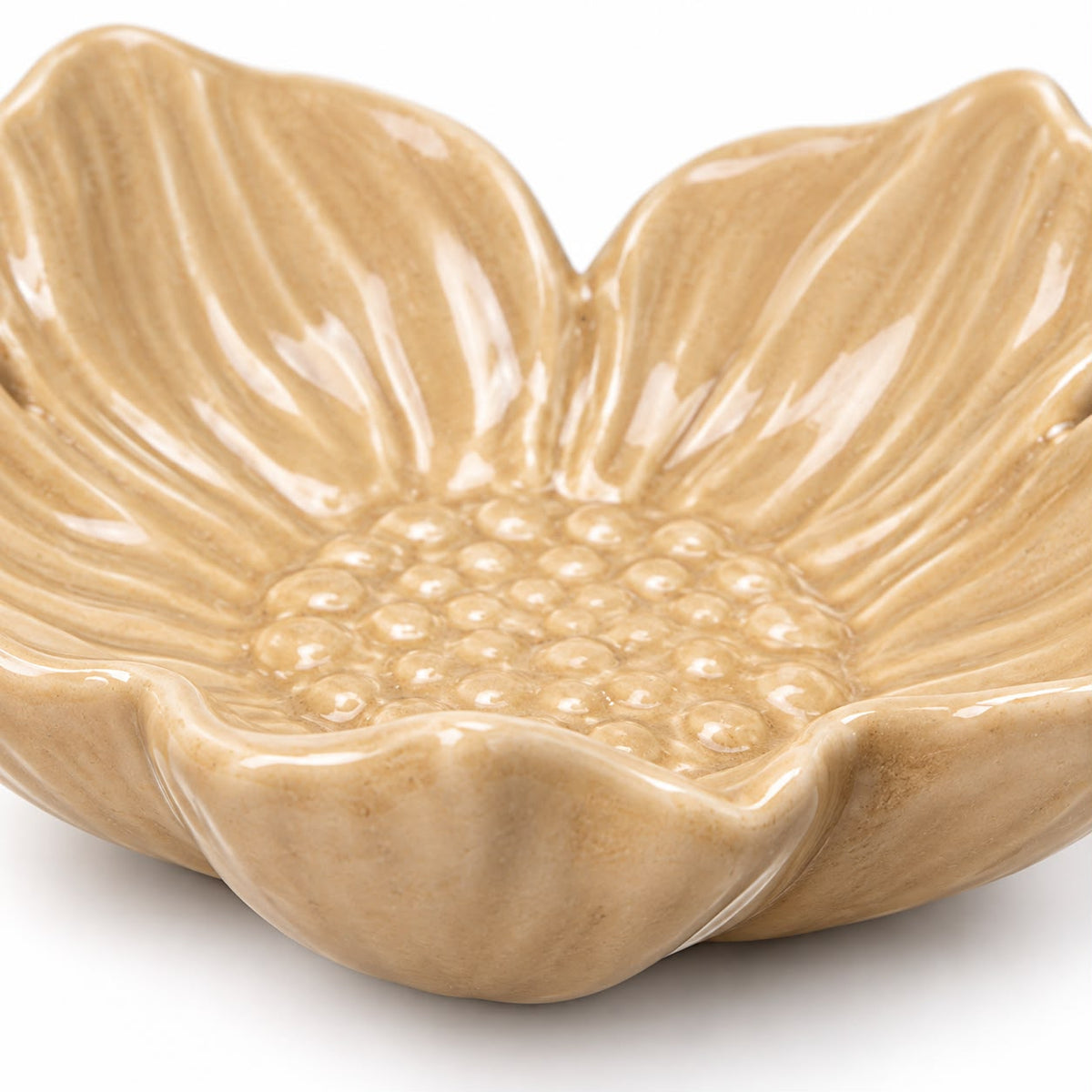 Close-up of glazed beige flower dish