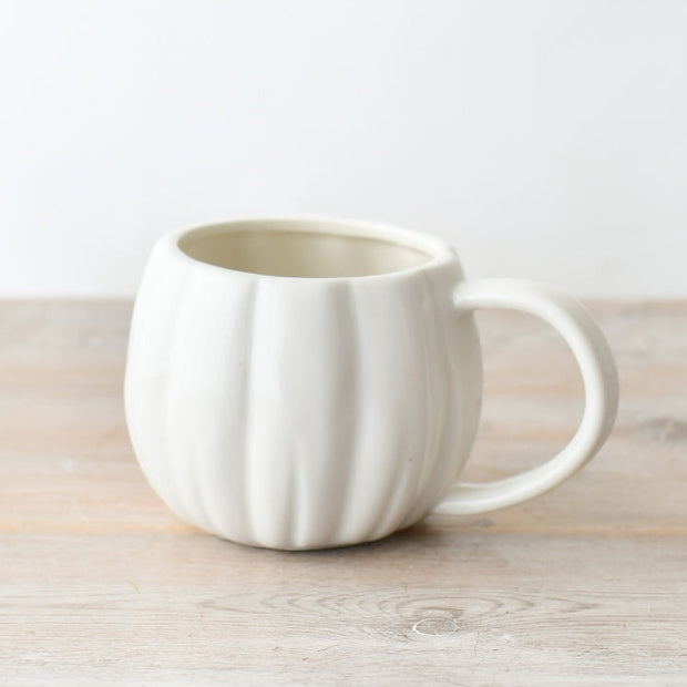 White Matt Ceramic Pumpkin Mug, white ribbed pumpkin mug against a pale background