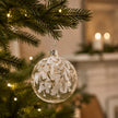 Clear Glass Bauble With White Leaves, clear bauble with white leaves hanging on a tree