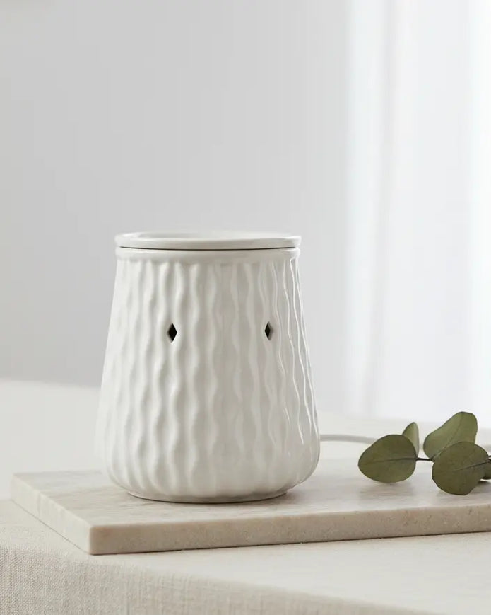 White Ripple Ceramic Wax Melt Burner by Devon Wick with a sleek design and glowing interior for aromatherapy use