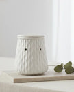 White Ripple Ceramic Wax Melt Burner by Devon Wick with a sleek design and glowing interior for aromatherapy use