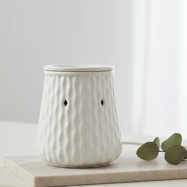 White Ripple Ceramic Wax Melt Burner by Devon Wick with a sleek design and glowing interior for aromatherapy use