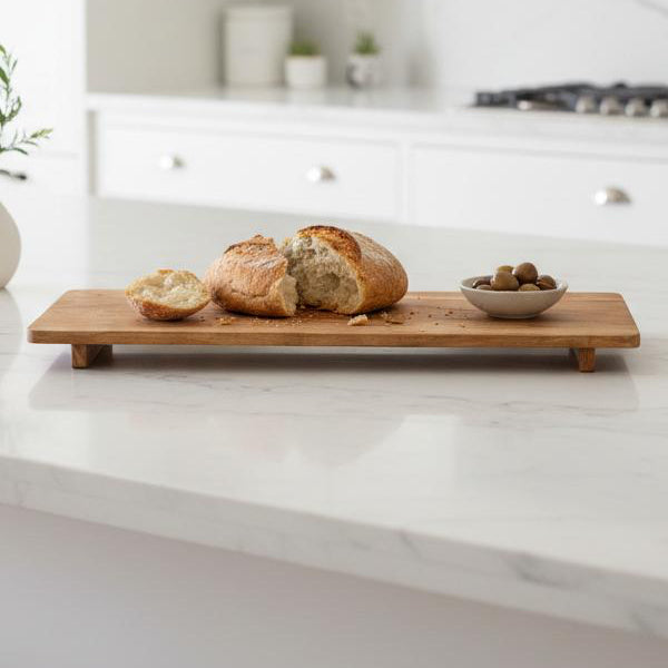 Large Footed Mango Serving Board, wooden footed board with bread on a kitchen island