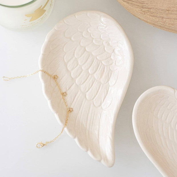 White angel wing Christmas trinket dish with intricate feather details, ideal for holiday decorative accents.