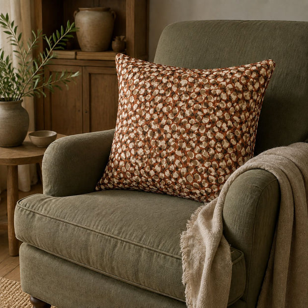 Rust Brown Print Cushion Cover, rust brown patterned cushion on a green armchair