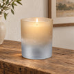 Faded Bronze Glass Tealight Holder, bronze and silver glass holder glowing on a wooden console