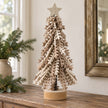 Twisted Brown Leaves Tree With Gold Star, layered tree with a gold star on a wooden console