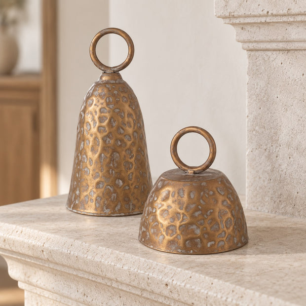 Brass Metal Cloche Cow Bell, two brass cloche bells on a stone mantel