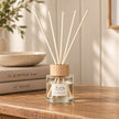 London Wax Company reed diffuser by Widdop & Co featuring blackcurrant and fig scent, with a glass bottle and reed sticks.