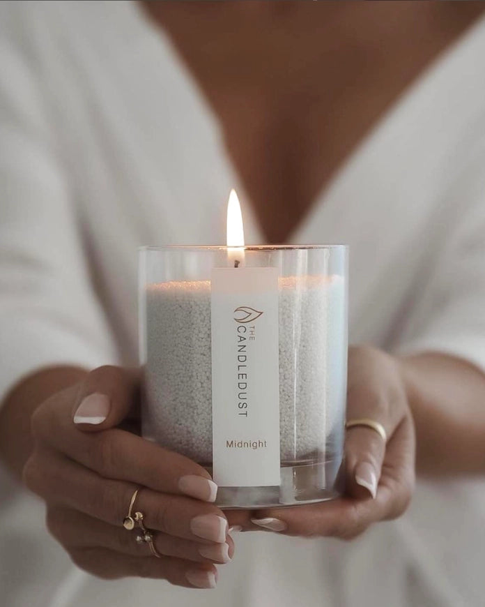 White scented candle in a sand jar with dark honey fragrance, from The Candledust home fragrance collection.