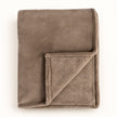 Beige Luxury Snuggle Blanket Throw, folded beige throw with its corner turned back on white