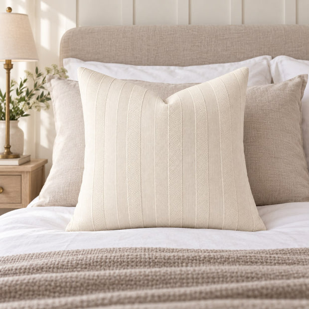 Ivory Cream Textured Stripe Velveteen Cushion Cover, ivory striped cushion against pillows on a bed
