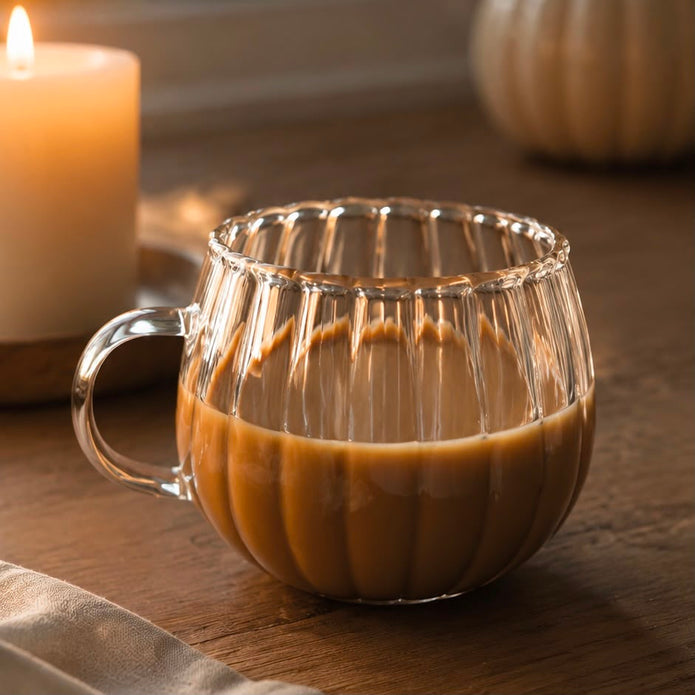 Glass Pumpkin Mug, clear ribbed pumpkin mug with a drink beside a candle