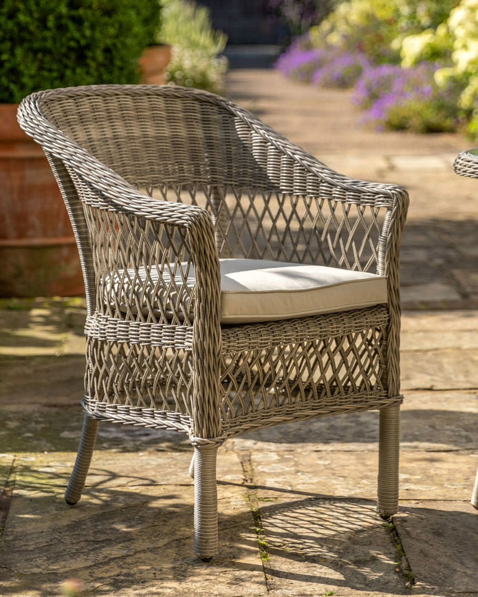 Natural rattan Menton two-seat bistro set for garden from Gallery Direct, featuring woven rattan chairs and matching table.