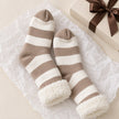 Cosy Slipper Socks - Beige Striped, beige striped slipper socks with fluffy cuffs beside a gift